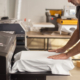 Side view of a man using machine to print graphic on tshirt