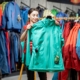 person picking out windbreaker in store